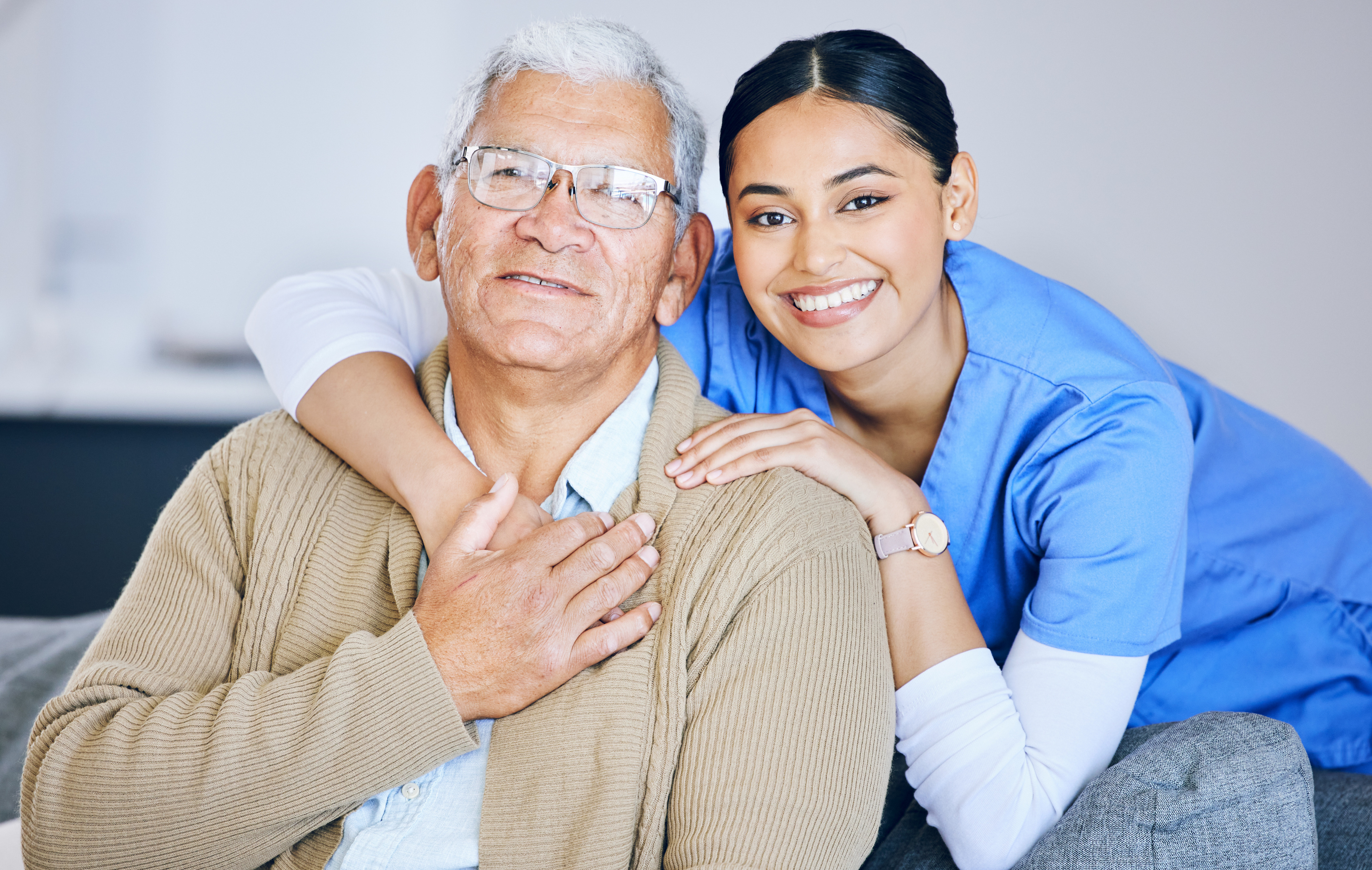 Old man, woman caregiver and portrait with retirement, health and wellness in nursing home. Happy people, female nurse and elderly male patient with hug, smile and healthcare with help and support.